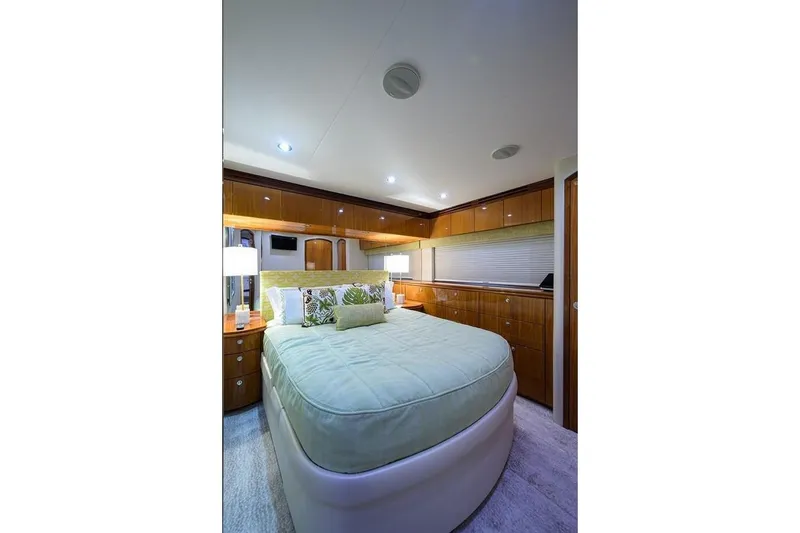 Slide: The Image of Luxurious bedroom interior of 2007 Hatteras 80 Motor Yacht with elegant wood finishes. - 24