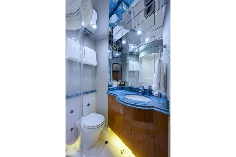 Slide: The Image of Luxurious bathroom in a 2007 Hatteras 80 Motor Yacht, featuring elegant fixtures and blue countertop. - 27
