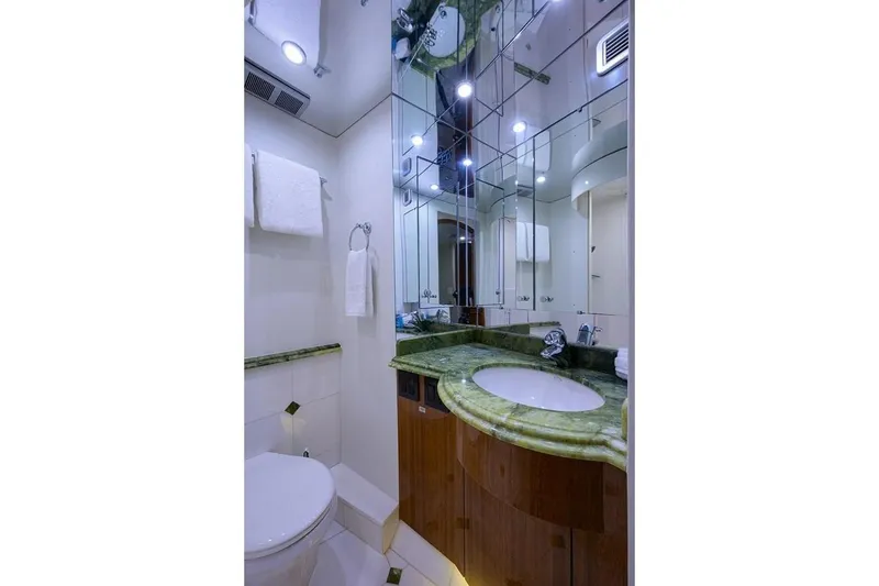 Slide: The Image of Luxurious bathroom in 2007 Hatteras 80 Motor Yacht with green marble countertop and mirrored walls. - 29