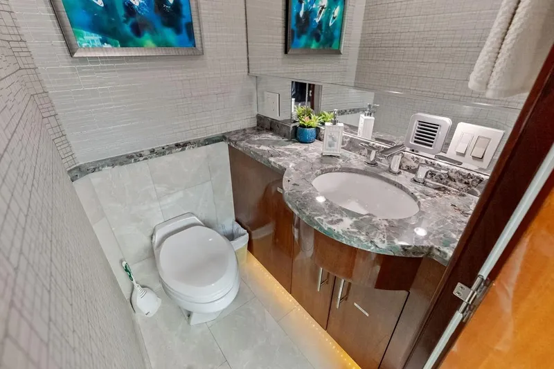 Slide: The Image of Luxurious bathroom in 2007 Hatteras 80 Motor Yacht with marble countertop and modern fixtures. - 19