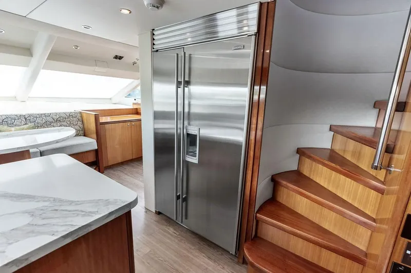 Slide: The Image of Interior of 2007 Hatteras 80 Motor Yacht with modern kitchen and wooden staircase. - 17