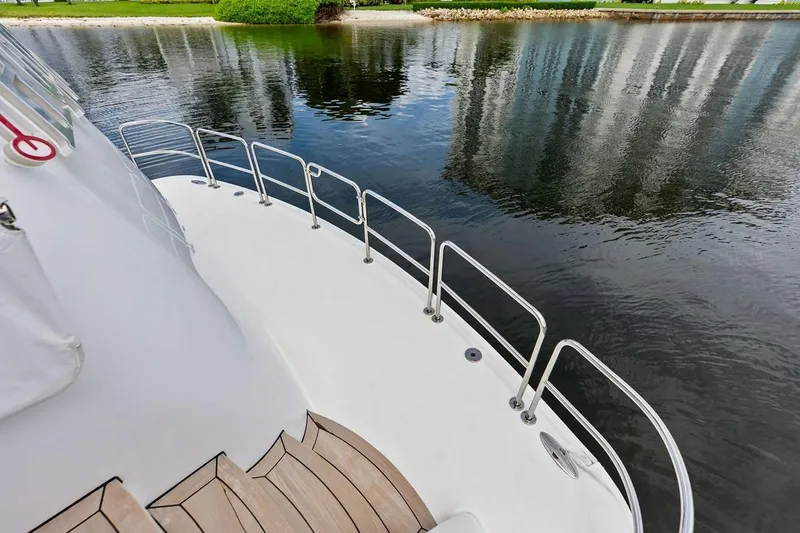 Slide: The Image of 2007 Hatteras 80 Motor Yacht deck overlooking calm water and shoreline. - 9