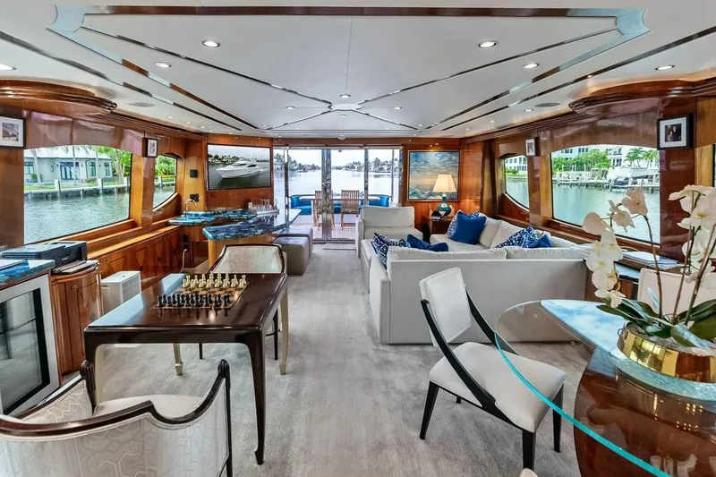 Slide: The Image of Luxurious interior of a 2007 Hatteras 80 Motor Yacht with elegant furnishings and waterfront views. - 10