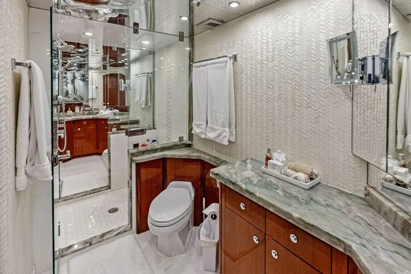 Slide: The Image of Luxurious bathroom in 2007 Hatteras 80 Motor Yacht with marble countertop and glass shower. - 24