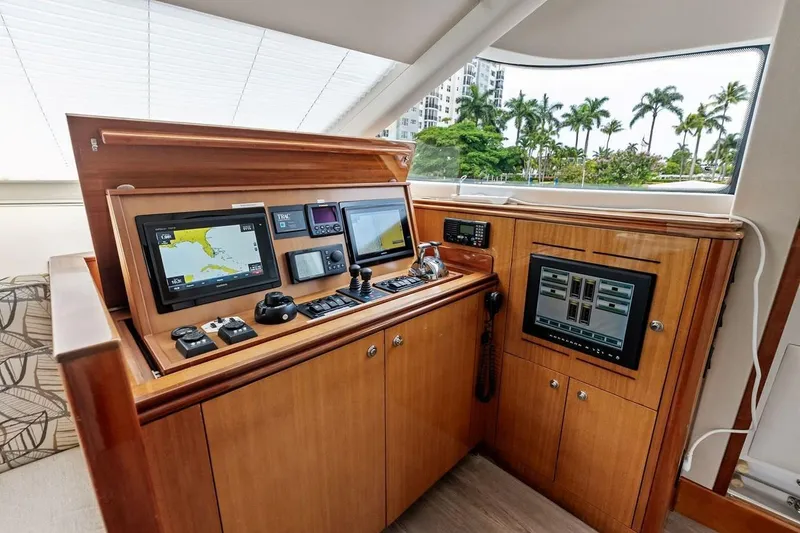 Slide: The Image of Control panel of a 2007 Hatteras 80 Motor Yacht with navigation screens and controls. - 18