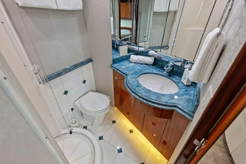 Slide: The Image of Luxurious bathroom in 2007 Hatteras 80 Motor Yacht with elegant blue countertop. - 34