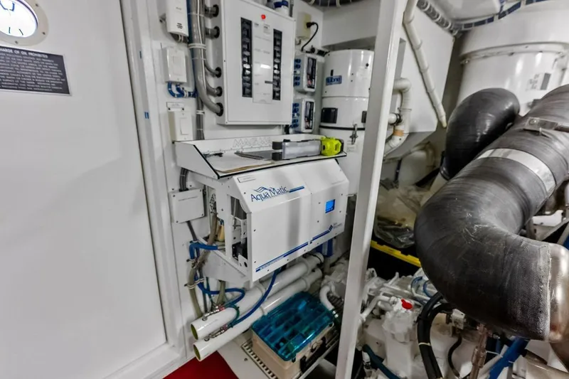 Slide: The Image of Engine room of 2007 Hatteras 80 Motor Yacht with control panels and machinery. - 58