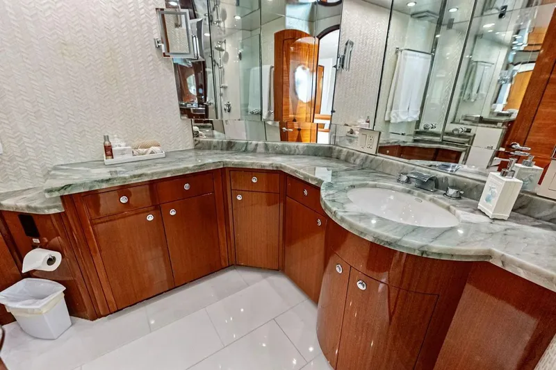 Slide: The Image of Luxurious bathroom in 2007 Hatteras 80 Motor Yacht with marble countertop and wooden cabinetry. - 26