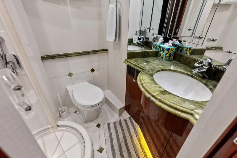 Slide: The Image of Luxurious bathroom in 2007 Hatteras 80 Motor Yacht with green marble countertop. - 36