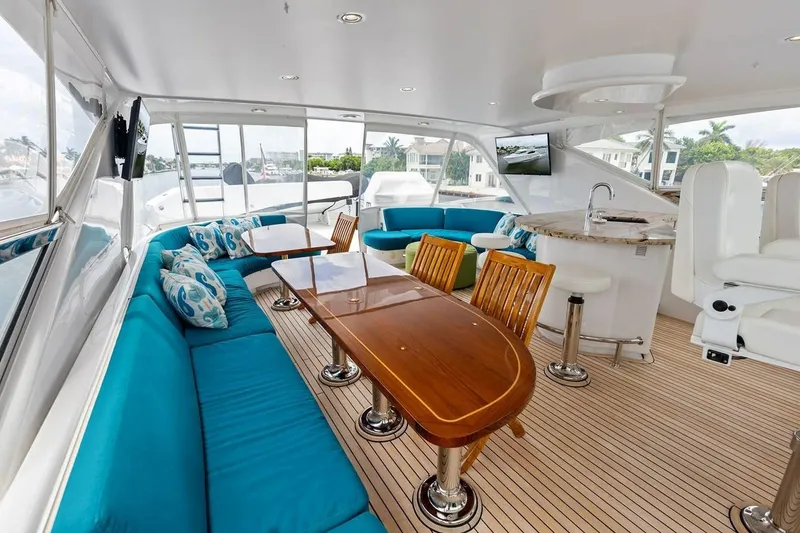 Slide: The Image of Luxurious interior of 2007 Hatteras 80 Motor Yacht with elegant seating and dining area. - 39