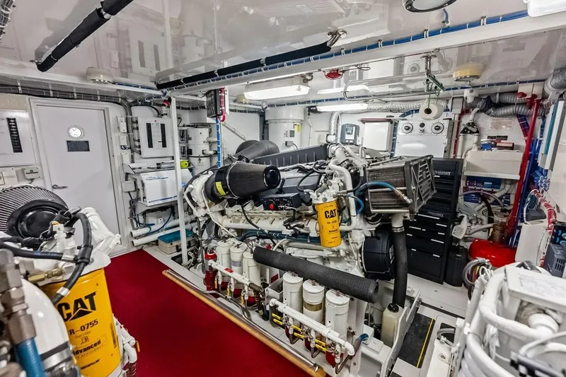 Slide: The Image of Engine room of a 2007 Hatteras 80 Motor Yacht, featuring CAT machinery and organized layout. - 55