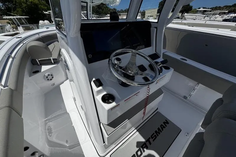 Slide: The Image of 2026 Sportsman Open 232 Center Console boat interior with steering wheel and seating. - 10