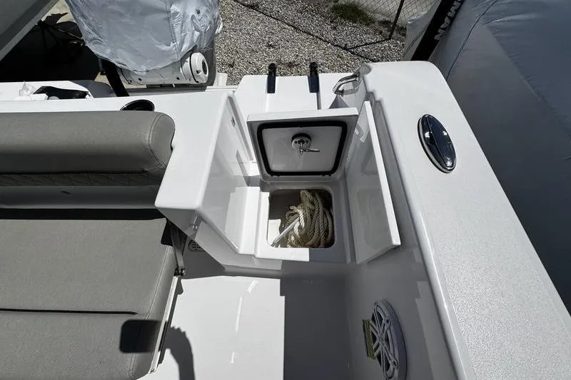 Slide: The Image of 2026 Sportsman Open 232 Center Console boat interior with seating and storage compartment. - 14