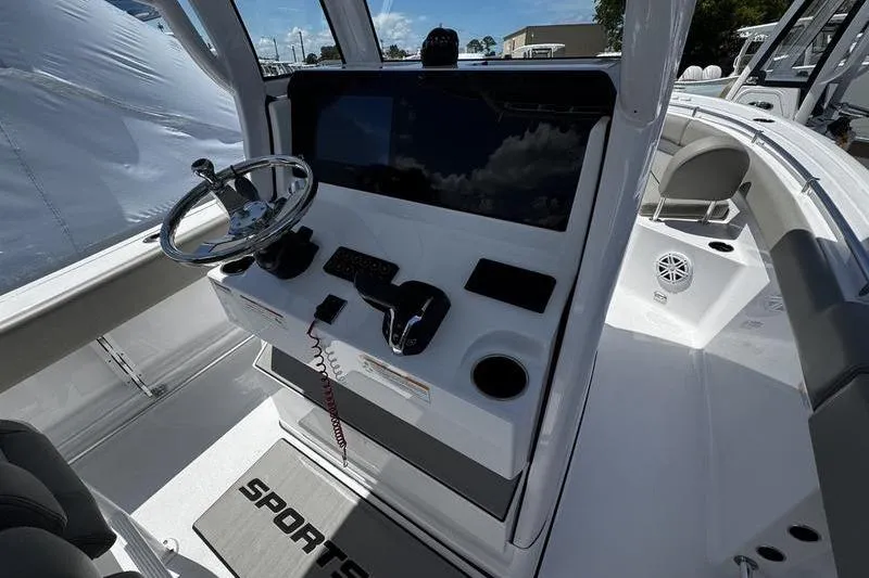 Slide: The Image of 2026 Sportsman Open 232 Center Console boat interior with steering wheel and control panel. - 16