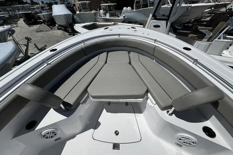 Slide: The Image of 2026 Sportsman Open 232 Center Console boat with cushioned seating and sleek design. - 17