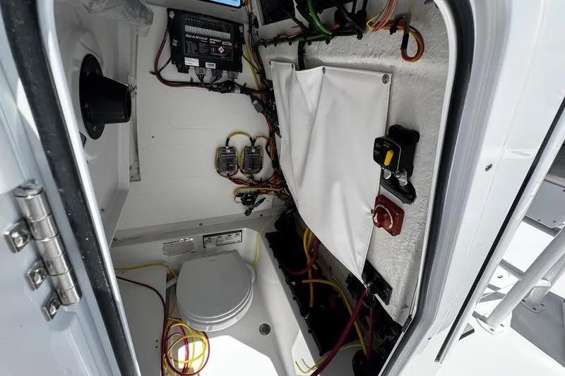 Slide: The Image of Interior view of 2026 Sportsman Open 232 Center Console boat's electrical compartment. - 18