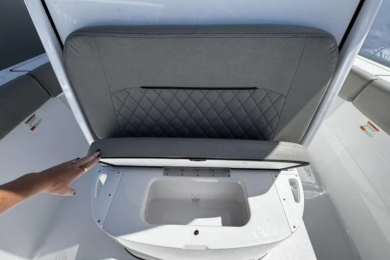 Slide: The Image of 2026 Sportsman Open 232 Center Console seat with storage compartment open. - 19