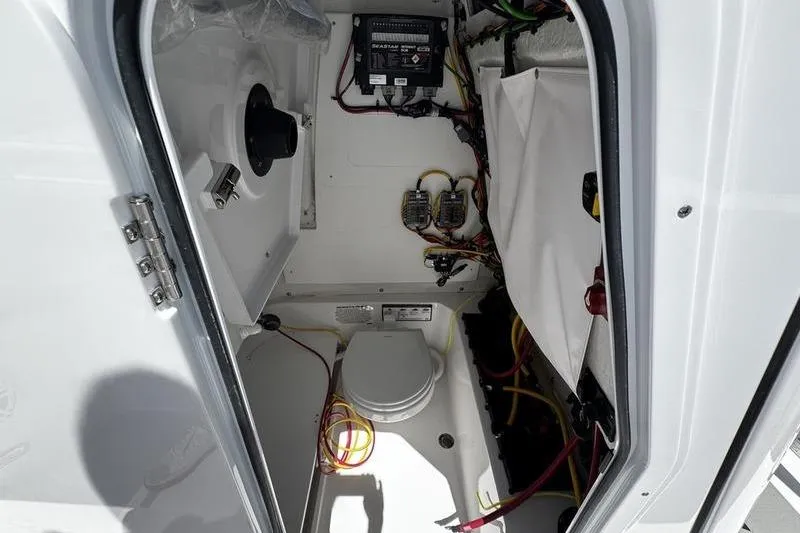 Slide: The Image of 2026 Sportsman Open 232 Center Console interior with wiring and equipment. - 2