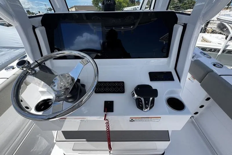 Slide: The Image of 2026 Sportsman Open 232 Center Console helm with steering wheel and controls. - 22