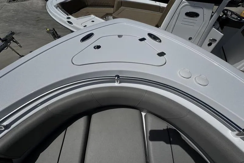 Slide: The Image of 2026 Sportsman Open 232 Center Console boat interior with cushioned seating and storage compartments. - 3