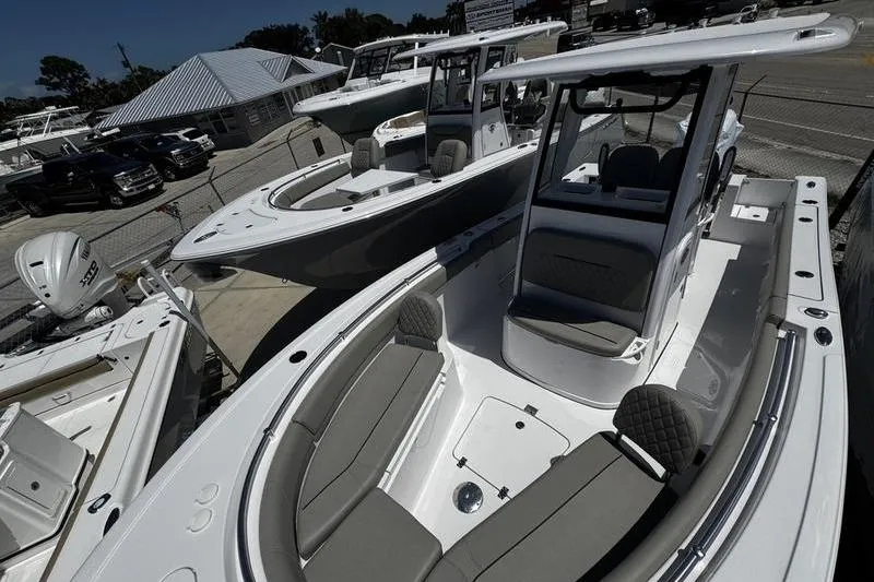Slide: The Image of 2026 Sportsman Open 232 Center Console boat displayed at a marina. - 6