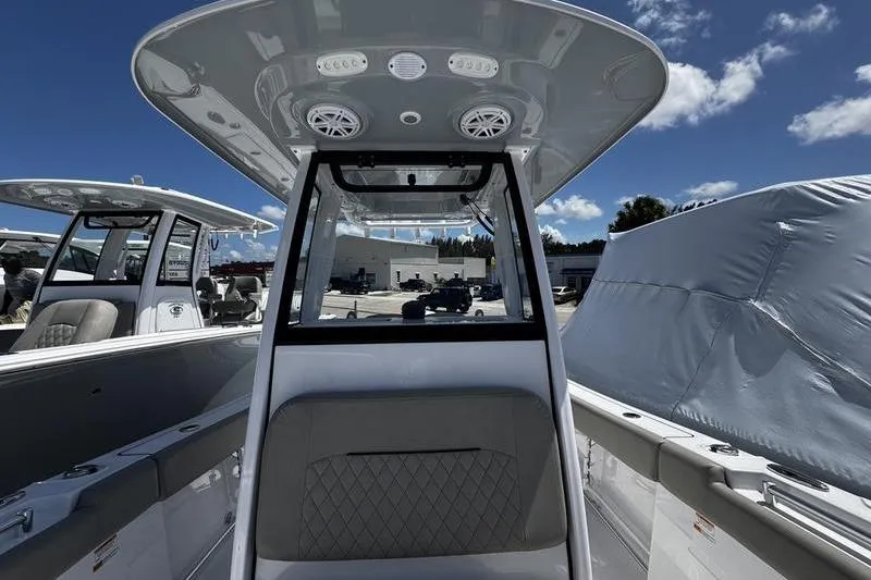 Slide: The Image of 2026 Sportsman Open 232 Center Console boat interior with speakers and seating. - 8