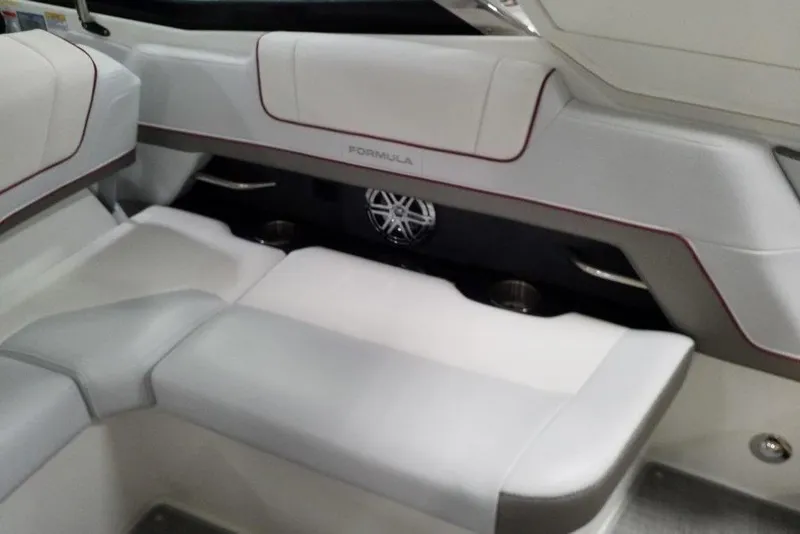 Slide: The Image of 2020 Formula 330 Crossover Bowrider interior with white seating and cup holders. - 13