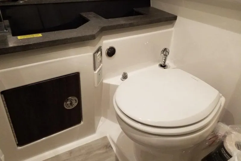 Slide: The Image of 2020 Formula 330 Crossover Bowrider bathroom with modern toilet and sleek countertop design. - 16