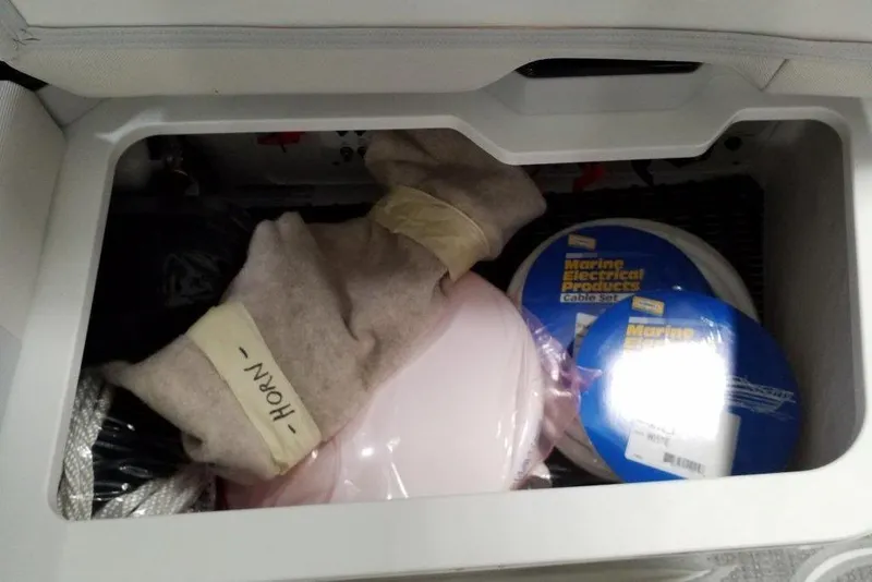 Slide: The Image of Storage compartment in a 2020 Formula 330 Crossover Bowrider with marine accessories. - 18