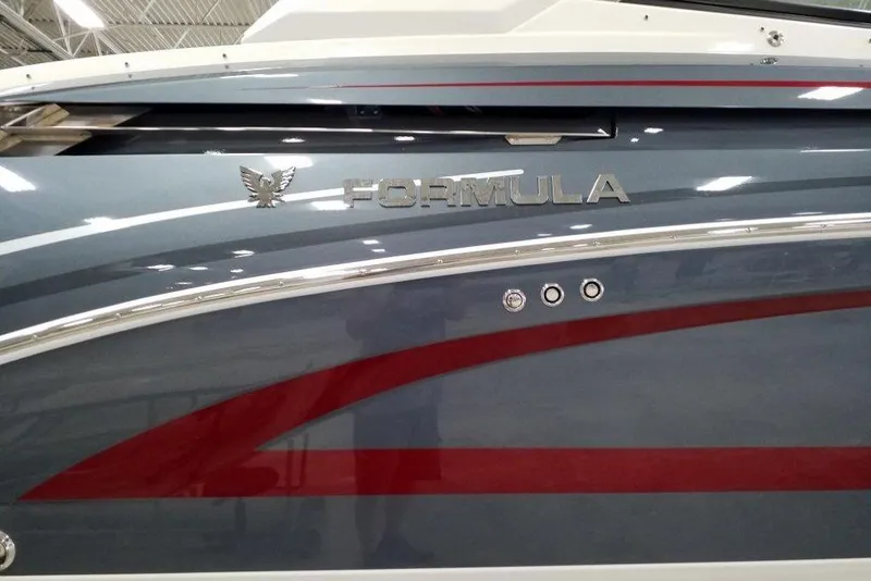 Slide: The Image of 2020 Formula 330 Crossover Bowrider boat with sleek design and metallic finish. - 2