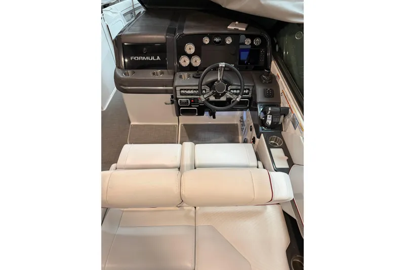 Slide: The Image of 2020 Formula 330 Crossover Bowrider cockpit with modern steering and controls. - 9