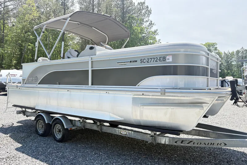 Slide: The Image of 2022 SunCatcher Select 22RF pontoon boat on trailer, parked outdoors. - 5