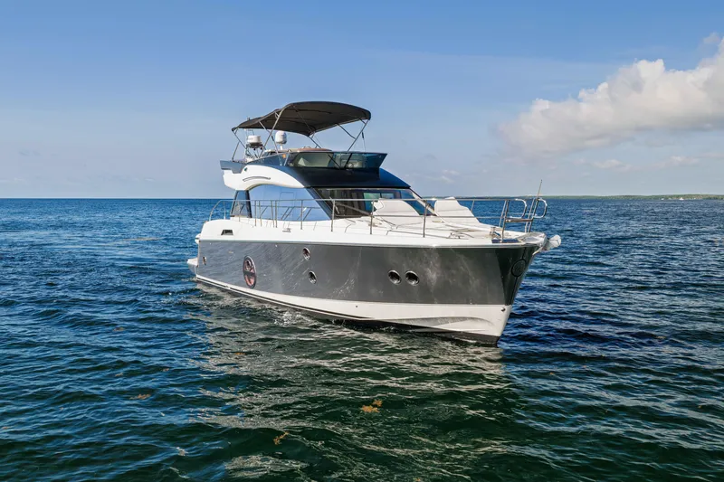 Slide: The Image of 2017 Monte Carlo Yachts MC5 cruising on open water under a clear blue sky. - 15