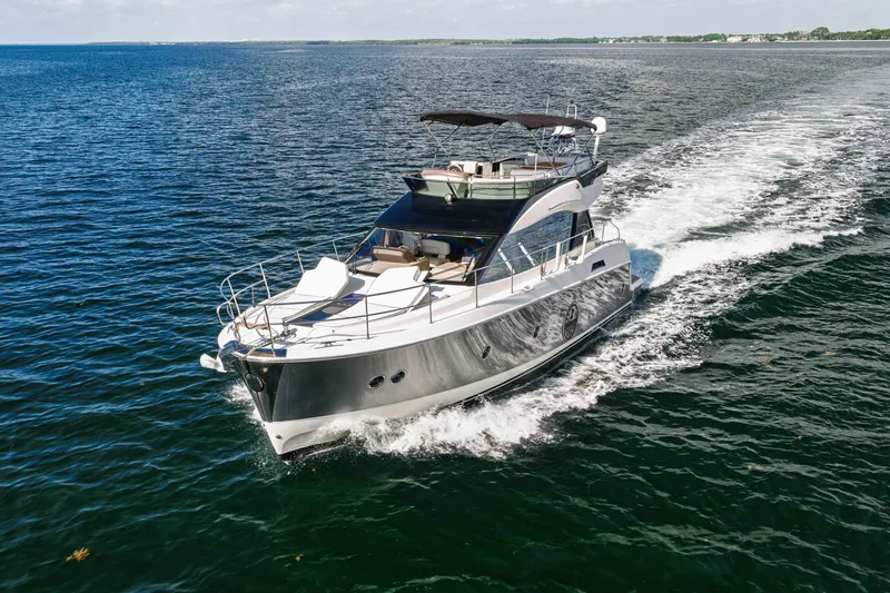 Slide: The Image of 2017 Monte Carlo Yachts MC5 cruising on open water, showcasing sleek design and luxury. - 4