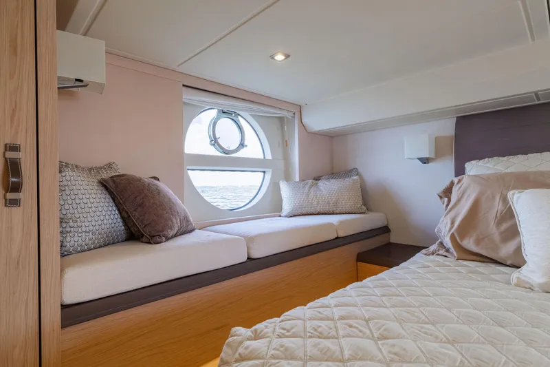 Slide: The Image of Luxurious interior of 2017 Monte Carlo Yachts MC5 with cozy seating and elegant bedding. - 70