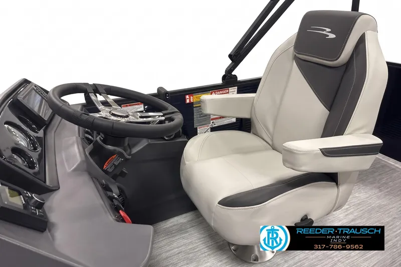 Slide: The Image of 2026 Bennington boat interior with steering wheel and captain's chair, Reeder-Trausch Marine logo. - 3