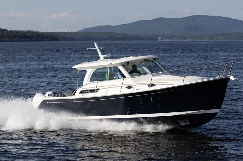 The Image of Manufacturer Provided Image: 2026 Back Cove 34O cruising on a scenic lake with mountains in the background. - 0