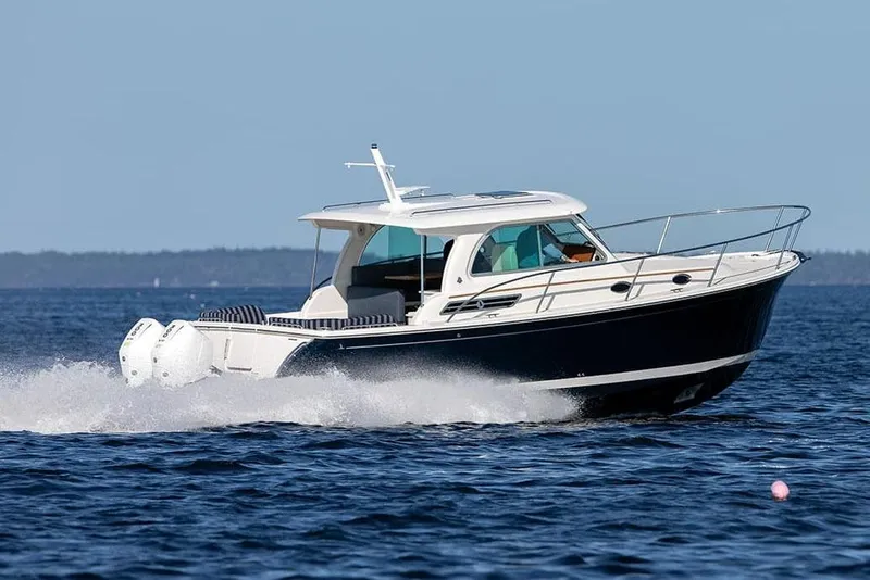 Slide: The Image of Manufacturer Provided Image: 2026 Back Cove 34O boat cruising on open water, showcasing sleek design and powerful engines. - 2