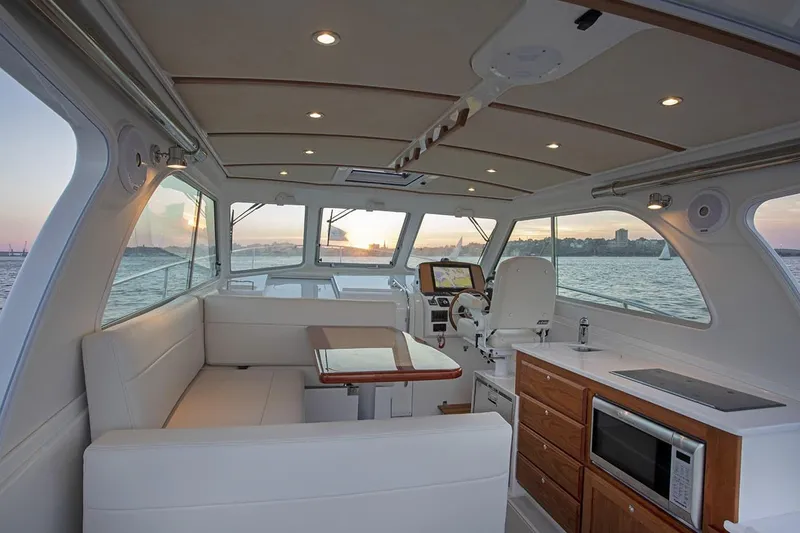 Slide: The Image of Manufacturer Provided Image: Interior of 2026 Back Cove 34O yacht with modern amenities and sunset view. - 4