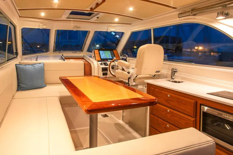 Slide: The Image of Manufacturer Provided Image: Interior of 2026 Back Cove 34O yacht with elegant seating and modern helm. - 7