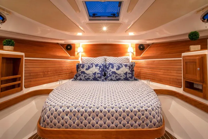Slide: The Image of Manufacturer Provided Image: Luxurious cabin interior of 2026 Back Cove 34O with elegant bedding and wooden accents. - 8