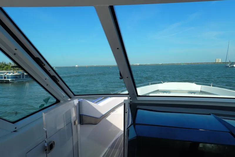 Slide: The Image of Interior view from a 2022 Formula 400 Super Sport Crossover yacht, overlooking a serene waterway. - 11