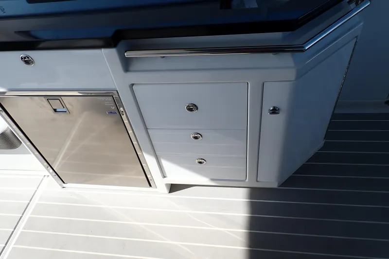 Slide: The Image of 2022 Formula 400 Super Sport Crossover boat interior with sleek cabinetry and stainless steel fridge. - 13