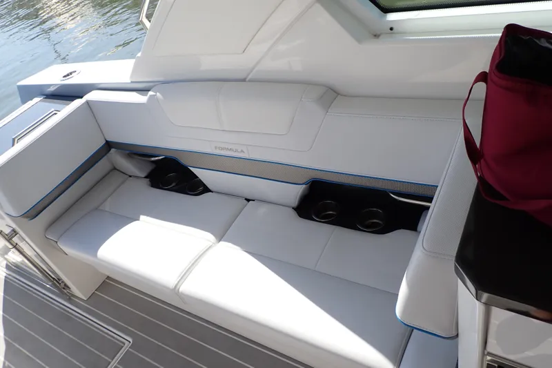 Slide: The Image of 2022 Formula 400 Super Sport Crossover boat interior with white seating and cup holders. - 29