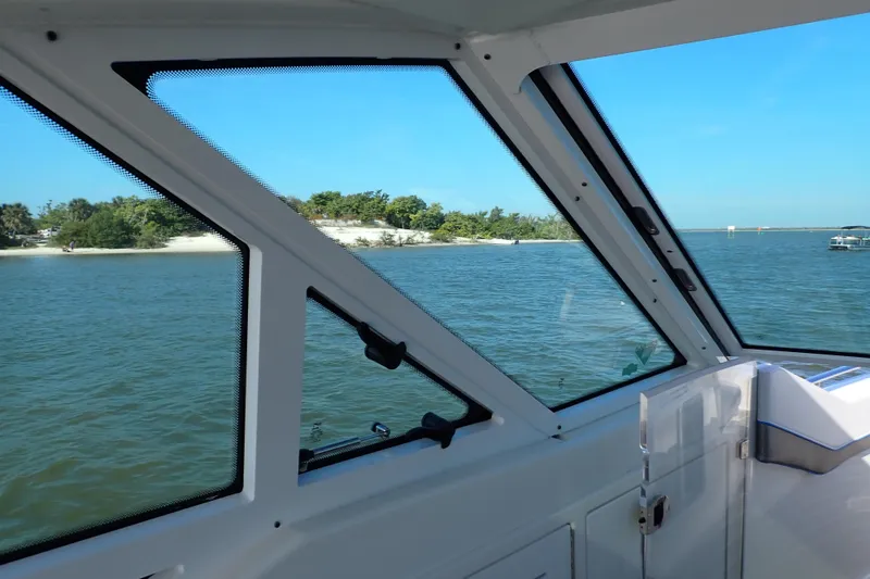 Slide: The Image of Interior view from a 2022 Formula 400 Super Sport Crossover boat, overlooking serene waters. - 9