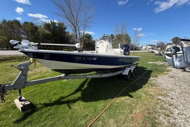 Slide: The Image of 2012 Pathfinder 2200 Tournament Edition boat on trailer, parked on grass under a clear sky. - 3