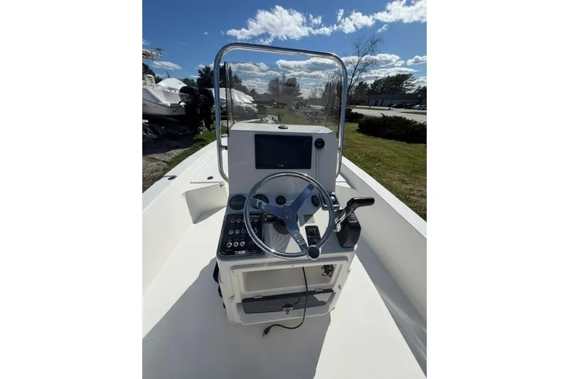 Slide: The Image of 2012 Pathfinder 2200 Tournament Edition boat console with steering wheel and controls. - 4