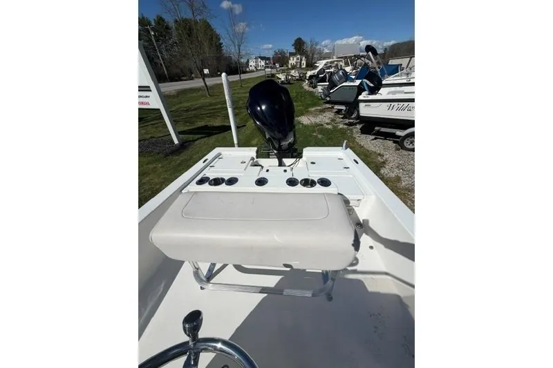 Slide: The Image of 2012 Pathfinder 2200 Tournament Edition boat with seating and motor, parked outdoors. - 5