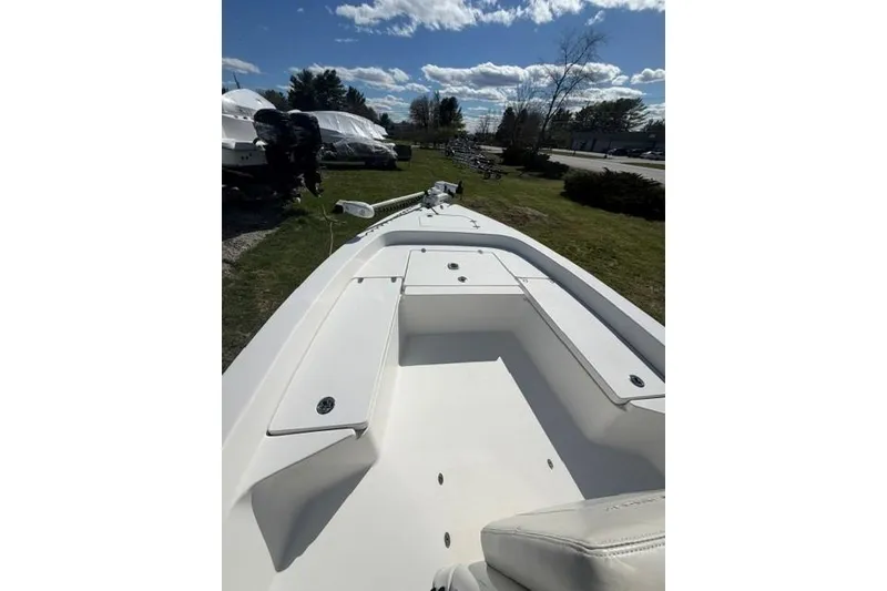 Slide: The Image of 2012 Pathfinder 2200 Tournament Edition boat, white interior, parked outdoors under a blue sky. - 6
