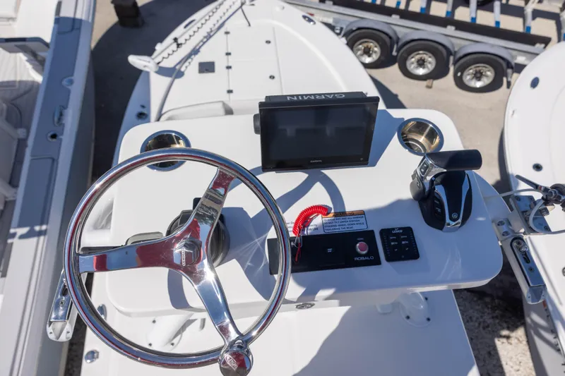 Slide: The Image of 2022 Robalo 246 Cayman SD boat helm with Garmin display and steering wheel. - 11